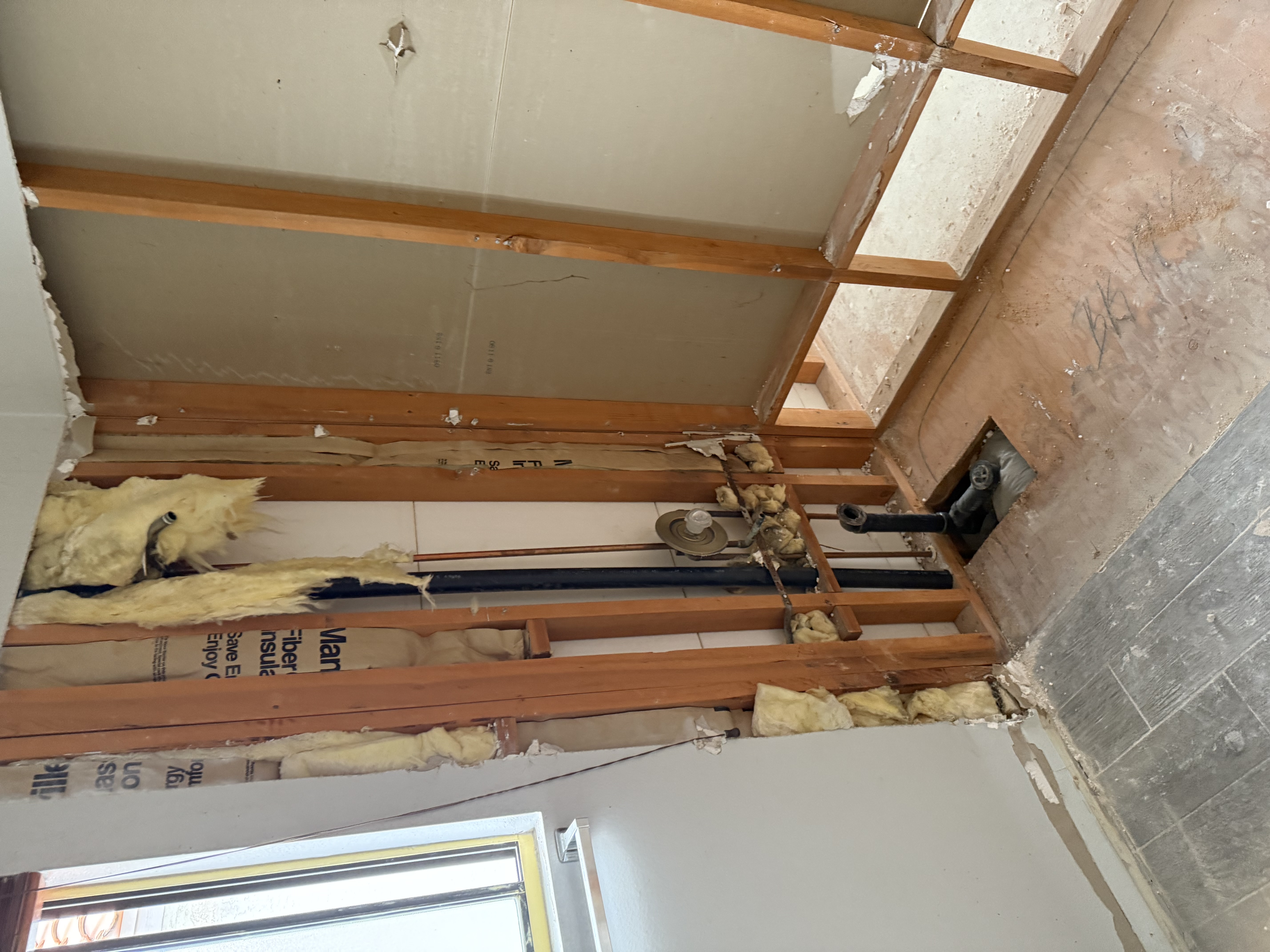Interior of a Las Vegas property with subfloor and framing exposed after flooding, awaiting industrial drying equipment