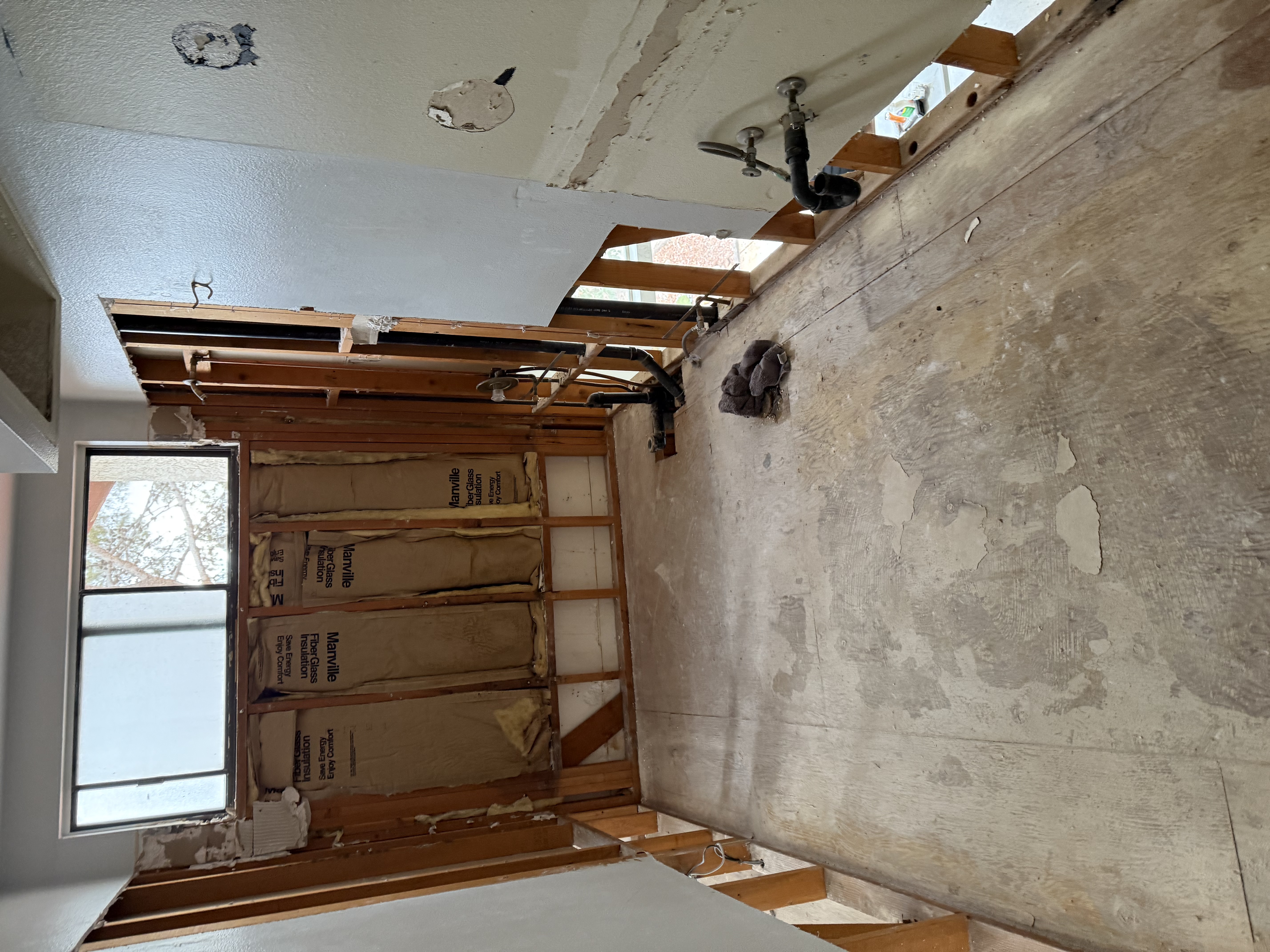 Bathroom walls stripped to the studs after severe water intrusion, exposing framing for moisture assessment in a Las Vegas home